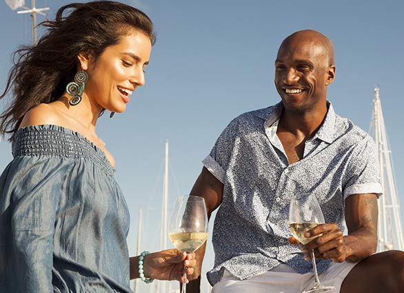 Man and Woman Holding Wine Glasses and Talking