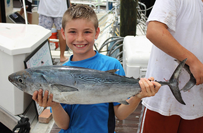 boy holding large fish